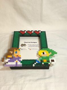 a lego frame with mario and luigi's adventure on it, sitting on a white sheet