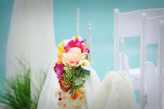 a bouquet of flowers sitting on top of a white chair