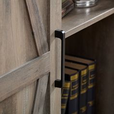 a book shelf with two books and a vase on it's side next to some books