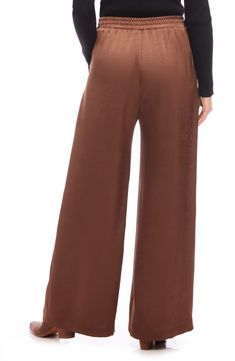 A versatile solid hue brings chic appeal to these flowy wide-leg pants crafted with a comfortable elastic waist. 29" inseam; 29" leg opening; 13" front rise; 16" back rise (size Medium) Pull-on style Front slant pockets 55% polyester, 45% recycled polyester Dry clean Made in the USA of imported fabric Brown Wide Leg Bottoms With Relaxed Fit, Fall Ankle-length Wide Leg Pants, Solid Wide Leg Full Length Pants For Fall, Chic Brown Bottoms With Elastic Waistband, Solid Color Full Length Wide Leg Pants For Fall, Fall Rayon Pants With Elastic Waistband, Brown Wide Leg Bottoms With Loosely Fitted Hips, Chic Relaxed Fit Brown Bottoms, Solid Full Length Wide Leg Pants With Elastic Waistband