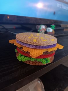 The viral burger coasters but made with Perler beads. Great for eclectic decor, but also very effective at its job. Flat layer of cork on the bottom allows for minimal water leakage. about 4in. diameter, and all pieces can fit a standard size can bottom. This 7 piece set includes: bottom bun, lettuce, tomato, burger, cheese, onion, and top bun. Hamburger Coaster Set, Burger Perler Beads, Perler Bead Light Switch Cover, Cute Perler Bead Coasters, The Office Perler Beads, Bobs Burgers Perler Beads, Perler Bead Coasters Patterns, Perler Beads Coasters, Perler Bead Coaster