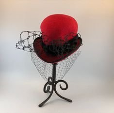 Elevate your fashion game with this exquisite Makshy red heart-shaped cocktail hat fascinator. This accessory is more than just a hat - it's a work of art, expertly crafted by hand in Great Britain. Designed to turn heads, it's the perfect way to add a touch of sophistication and playfulness to any outfit. HAT FEATURES ◦ Unique heart shape achieved through the use of the milliner's own hand-crafted hat block. ◦ Crafted with intricate details and reinforced with millinery wiring to maintain the hat brim's shape over time. ◦ Individually hand-sewn for exceptional attention to detail. ◦ Lined with luxurious silk for added comfort and style. ◦ Custom-made to order for a truly bespoke experience. The fascinator is crafted from high-quality wool felt, renowned for its durability, warmth, and sof Formal Winter Red Felt Hat, Red Fitted Felt Hat For Formal Occasions, Elegant Red Felt Hat For Formal Occasions, Elegant Fitted Red Felt Hat, Formal Red Fitted Felt Hat, Elegant Fitted Felt Mini Hats, Elegant Red Cloche Hat For Winter, Red Fitted Hat For Gift, Red Felt Party Hat For Winter