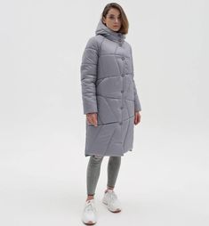 This women's winter puffer jacket features a semi-fitted silhouette with set-in sleeves. Key details include: Outer Fabric: Laca fabric insulated with silicone. Lining: Nylon, insulated with synthetic padding. Quilting: The puffer is adorned with decorative stitching. Pockets: Integrated into the decorative stitching on the front panels. Hood: Set-in hood. Closure: Snap buttons. Sleeve Length: 65 cm. Back Length: 105 cm. Fabric Composition: 100% polyester. This stylish puffer jacket combines war Gray Hooded Puffer Outerwear, Gray Puffer Jacket For Winter Cold Weather, Gray Puffer Outerwear For Cold Weather, Gray Puffer Outerwear For Fall, Gray Puffer Jacket For Cold Weather, Quilted Outerwear For Winter, Quilted Long Sleeve Puffer Jacket, Gray Down Puffer Outerwear, Gray Fall Puffer Outerwear