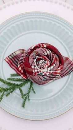 a red and white plaid flower on a plate