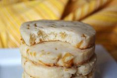 three cookies stacked on top of each other in front of a yellow striped pillow,