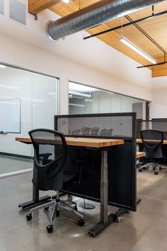 an empty office space with desks and chairs