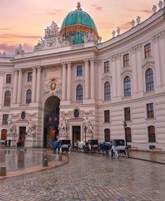 a large building with many people walking around it