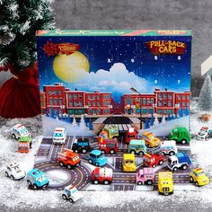 a christmas scene with cars and trucks on the road in front of a large cardboard box