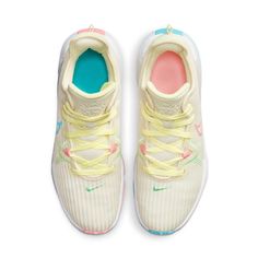 a pair of white sneakers with blue, yellow and pink accents on the soles