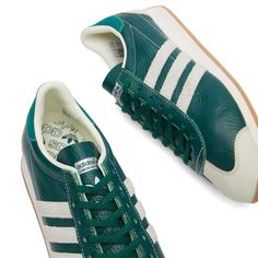 Find ADIDAS Country Og W on Editorialist. Hand-picked from their vast archives and given a new lease of life, the adidas Country Og are just as iconic now as they were in the 80s. Released in deep collegiate green leather, they feature contrast stitching and a retro Trefoil logo on the tongue. The iconic three stripes appear on the sidewalls as usual, this time in textured suede. Leather Upper, Synthetic Lining, Embossed Branding, EVA Midsole, Gum Rubber Outsole, Adidas. Adidas Women's Country O Green Leather Sneakers With Three Stripes Branding, Classic Green Adidas Sneakers, Green Adidas Sneakers With Three Stripes, Retro Green Adidas Sneakers, Green Sporty Sneakers With Three Stripes Branding, Sporty Green Sneakers With Three Stripes Branding, Green Adidas Sporty Sneakers, Green Sporty Sneakers With Three Stripes, Green Three Stripes Sports Sneakers