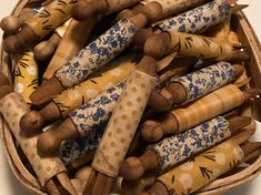 a basket filled with lots of different sized wooden dowks on top of a table