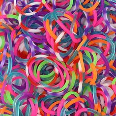 many different colored rubber bands are scattered together