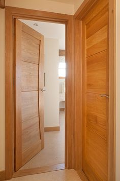 an open wooden door in a white room