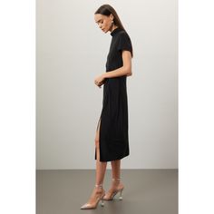 Black jersey (57% Polyester, 38% Recycled Polyester, 5% Polyurethane). A-line. Short sleeves. Turtleneck Back zipper closure. 49" from shoulder to hemline. Imported. Sleek A-line Midi Dress For Spring, Spring Evening Midi Dress With Side Zipper, Black Knee-length Dress, Knee-length Midi Dress With Side Zipper For Night Out, Black Midi Dress With Side Slits For Work, Black Workwear Dress With Side Slits, Black Work Dresses With Side Slits, Black Knee-length Dress With Side Slits, Sleek Knee-length Midi Dress With Side Slits