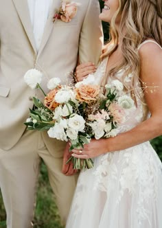 the bride and groom are holding their bouquets