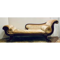 an old fashioned chaise lounge is on display in a room with tile flooring