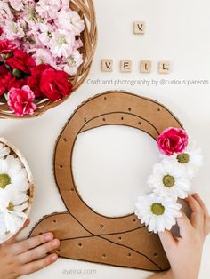 someone is making a flower wreath out of cardboard and paper maching the letter q