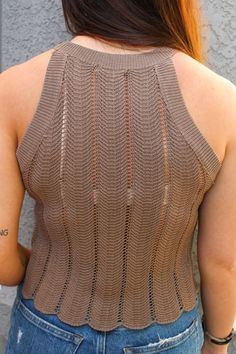 the back of a woman's top that is knitted