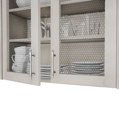 a cabinet with plates and cups in it