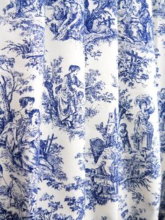 a blue and white toiler print curtain with an image of people on it