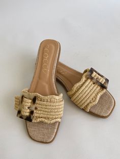 The Leslie Buckle Sandal offers effortless style with its flat slip-on design. The raffia strap adds a touch of texture, while the tortoise buckle detail adds a hint of sophistication. Perfect for any summer look, these sandals provide both comfort and fashion-forward appeal. Heel: 0.25" Bali Clothing, Vintage Havana, Buckle Sandals, Curvy Dress, Graphic Tops, Fashion Sandals, Summer Look, Resort Wear, Summer Looks