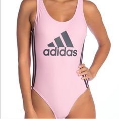 New With Tags Adidas One-Piece Swimsuit With A Low Cutout Back. Solid Pink With Grey Adidas Logo Front Center And 3-Stripe Sides. Nylon And Spandex With Polyester Lining. No Damage Or Defects. Smoke And Pet Free Home. Pink Sleeveless Bodysuit For Sports, Pink Sleeveless Sports Bodysuit, Pink Sports Swimwear, Sporty Pink Bodysuit For Summer, Casual Pink Workout Bodysuit, Casual Pink Bodysuit For Workout, Trendy Pink Workout Swimwear, Trendy Pink Swimwear For Workout, Sporty Pink Bodysuit For Sports