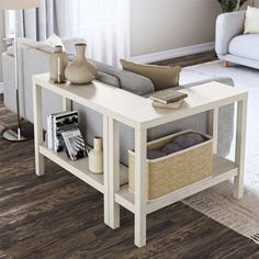 a living room with white furniture and wood floors