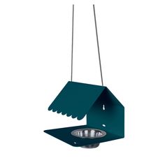 a bird feeder hanging from the ceiling with a metal bowl below it and a green roof