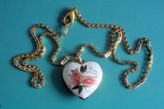 "Vintage handpainted cloisonne enamel heart-shape pendant necklace with multicolor flower motive on white bottom and goldcolor metal chain. Painting made on copper base, pendant alike at both sides and chain closed by lobster clasp. Size:    chain 16 \"/ inch or 40.5 cm long, pendant 1.2 \"/ inch or 3 cm long with loop, 0.9 \"/ inch or 23 mm wide. Exellent vintage condition!" Vintage Enamel Heart Necklaces, Vintage Heart Enamel Necklaces, Vintage Enamel Heart Necklace, Vintage Heart Enamel Necklace, White Enamel Hand Painted Necklace, White Hand Painted Enamel Necklace, Hand Painted White Enamel Necklace, White Hand Painted Heart Jewelry, Hand Painted White Heart Jewelry