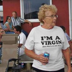 an older woman wearing a t - shirt that says i'm a virgin but this is an old shirt