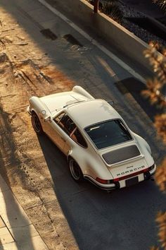 a white car is parked on the side of the road