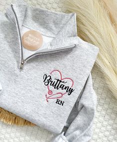 Personalized RN Quarter Zip, Nurse Graduation Gift, Embroidered Nurse Sweatshirt, RN Sweatshirt, Custom nurse gift, Nurse Shirt, RN gift first picture is ash sweatshirt ---HOW TO ORDER---   FOR EACH SHIRT CHOOSE: **Shirt type, size and color 1) Name on Shirt 2) RN is auto added, if not needed let us know 3) Heart color and words color Please note: If we don't receive all needed custom details, , we will make it to the default, thread color and sleeve type based on the color ordered ---UNISEX SIZ Casual Sweatshirt With Machine Embroidery As Gift, Casual Machine Embroidered Sweatshirt As Gift, White Embroidered Sweatshirt As Gift, Crew Neck Tops With Machine Embroidery For Gifts, Long Sleeve Tops With Custom Embroidery As Gift, Custom Embroidered Long Sleeve Tops As Gift, Long Sleeve Tops With Embroidered Text For Gift, Long Sleeve Sweatshirt With Machine Embroidery As Gift, White Embroidered Sweatshirt For Gift