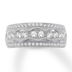 a wedding band with three diamonds on the top and bottom, set in 18k white gold