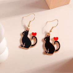 Black Cat With Heart Dangle Earrings. Perfect Gift For The Cat Lover. New In Package. Measures About 1". Black Cat Design Drop Earrings, Cute Black Earrings For Valentine's Day, Black Earrings For Valentine's Day, Black Cat Ears Jewelry For Gifts, Black Cat Ears Jewelry As A Gift, Black Heart Dangle Earrings For Gift, Black Metal Earrings For Valentine's Day, Cute Black Cat Design Earrings, Cute Black Dangle Jewelry