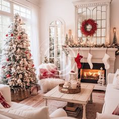 a living room filled with white furniture and christmas decorations