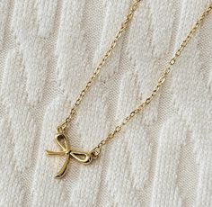 This tiny gold bow necklace is so cute and trendy.  It's the perfect dainty, minimalist jewelry!   Chain is adjustable from 15" - 18". Chic Gold Necklace With Bow, Dainty Adjustable Bow Necklace, Dainty Adjustable Necklaces With Bow, Dainty Adjustable Necklace With Bow, Minimalist Gold Jewelry With Bow, Trendy Bows, Delicate Gold Necklace, Jewelry Chain, Bow Necklace