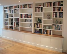 the bookshelves are lined up against the wall