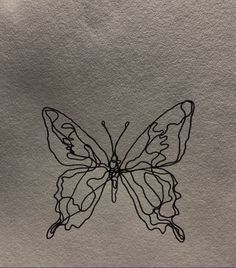 a drawing of a butterfly sitting on top of a piece of paper with black ink