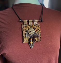 This textile necklace is a wearable art statement piece.  Made totally from recycled materials, it's a celebration of boho style. Measuring 3 1/2" x 2 3/4", the piece features handmade fabric feathers, copper attachments, a wooden button, wooden jewelry pieces and embroidery. The necklace cord is leather and adjusts with a sliding knot. Free shipping.  USA only. Fabric Mixed Media, Collage Jewelry, Mixed Media Necklace, Fiber Necklace, Fabric Feathers, Diy Jewellery Designs, Art Statement, Fiber Art Jewelry, Textile Necklace