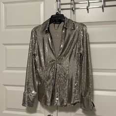 Zara, Beautiful, Silver Sequin Top, Pointed Collar, Relatively Low, V-Neck, Long Sleeves. Hook, And I Closure In The Front Cuffs Do Not Have Button Closure Never Worn, Marked As A Small But Fits Like A Medium.Smoke-Free Pet Free Home Shoulders Left Or Right 14 “ Length Top To Bottom 21 “ Sleeves 23” Really Pretty, And Fashionable, Not Fully Lined Spring Glamorous Shiny Blouse, Glamorous Shiny Blouse For Spring, Chic Shiny Blouse For Party, Glamorous Fitted Shiny Blouse, Shiny Long Sleeve Party Blouse, Long Sleeve Shiny Blouse For Party, Elegant Fitted Silver Top, Glamorous Fitted Silver Top, Shiny Party Blouse For Fall