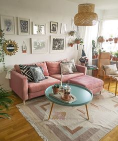 a living room filled with furniture and lots of pictures on the wall above it's coffee table