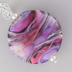 A handmade pink and purple glass bead in an organic pattern on a long sterling silver chain Pink Accessories, Pink And Silver, Purple Glass, Pink Glass, Pink And Purple, Sterling Silver Necklace, Glass Bead, Fine Silver, Stripes Design