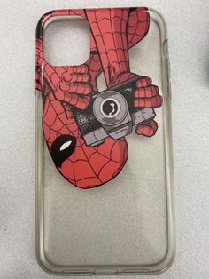 a phone case with a spiderman holding a camera