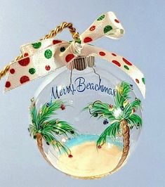 a glass ornament with palm trees and the words merry beachma on it