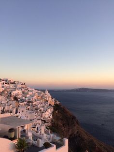 white buildings on the edge of a cliff overlooking the ocean