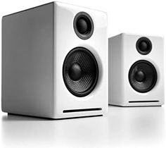 two white speakers sitting next to each other