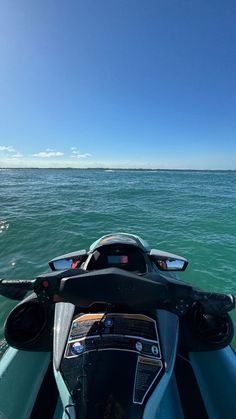 the back end of a jet ski with water in the background on a sunny day