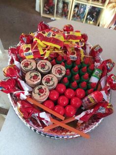 a bowl filled with candy and candies on top of a table