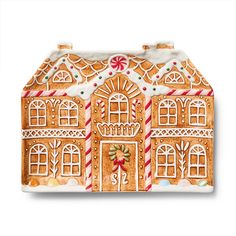 a ceramic gingerbread house ornament with candy canes