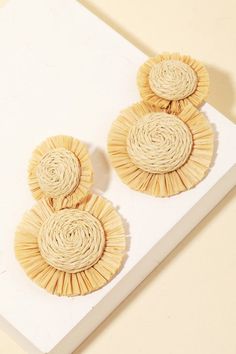 A must-have addition to any accessory collection, this pair of drop earrings shows off a distinctive raffia straw circle disc drop earrings design. White Wicker Earrings, Elegant Woven Earrings For Spring, Chic Woven Earrings For Vacation, Chic Woven Jewelry For Vacation, Spring Beach Tassel Earrings, Spring Beach Tassel Drop Earrings, Chic Summer Woven Jewelry, Chic Woven Summer Jewelry, Spring Vacation Woven Jewelry